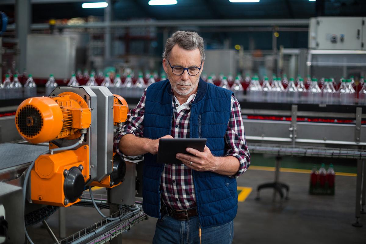 Factory worker using a digital tablet